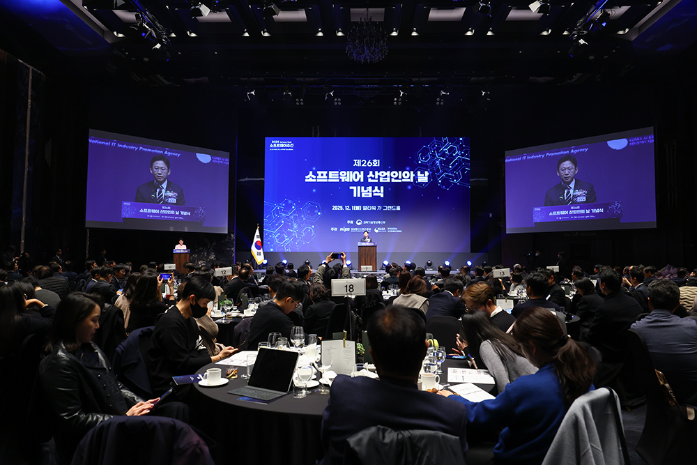第 26 届软件产业人日纪念仪式会场全景。2025 年 12 月 1 日于 L Tower 7 层大厅举行，大屏幕上打出仪式标题